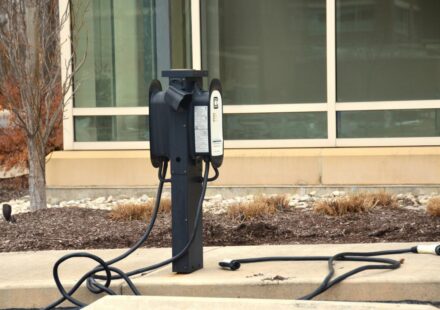 An old fashioned telephone is on the sidewalk