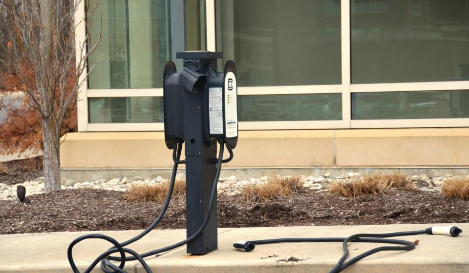 An old fashioned telephone is on the sidewalk