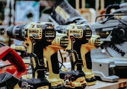 yellow Dewalt hand drills on table