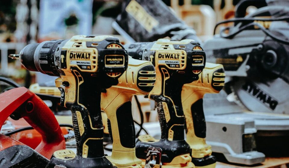 yellow Dewalt hand drills on table