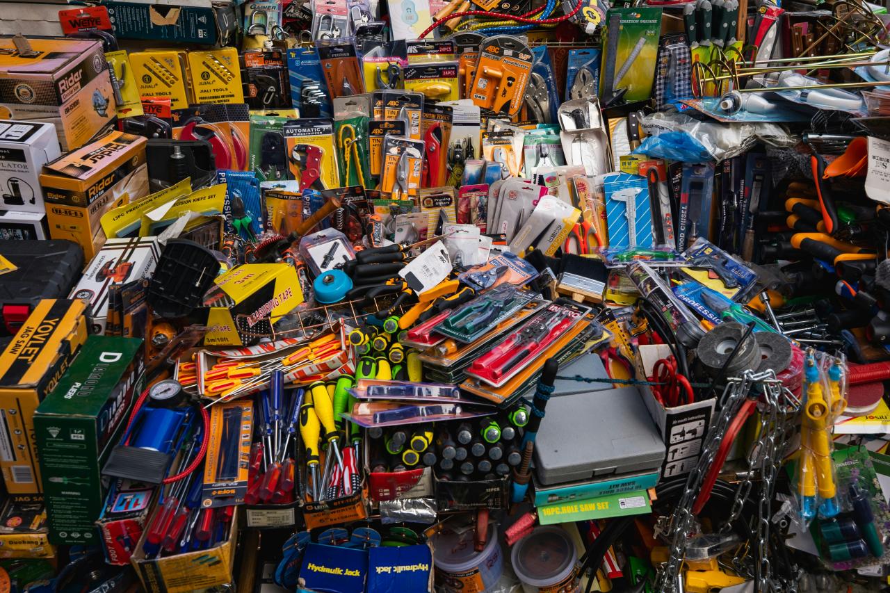 A cluttered display of various tools and hardware items