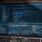 Laptop screen displaying lines of code with glasses