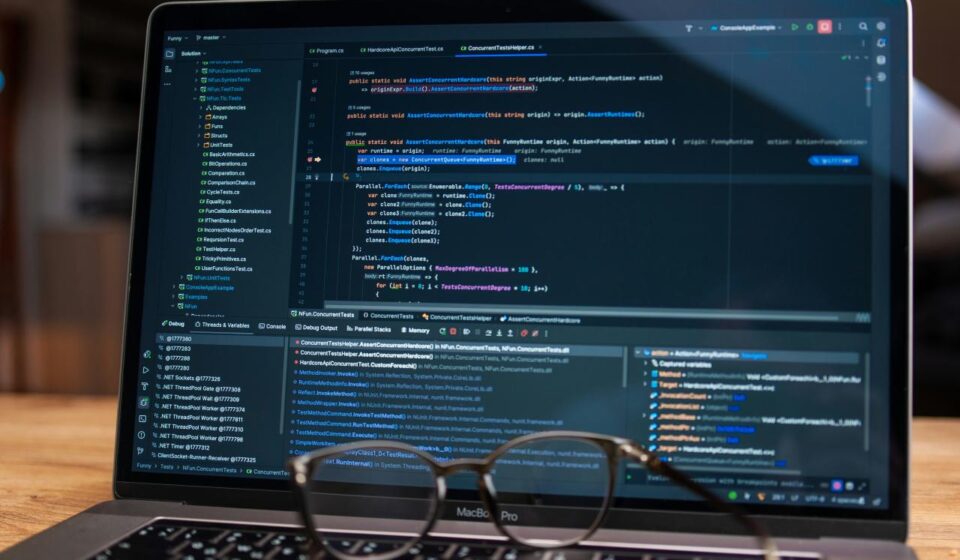 Laptop screen displaying lines of code with glasses