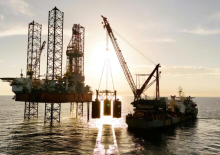 An oil rig being serviced by a supply ship