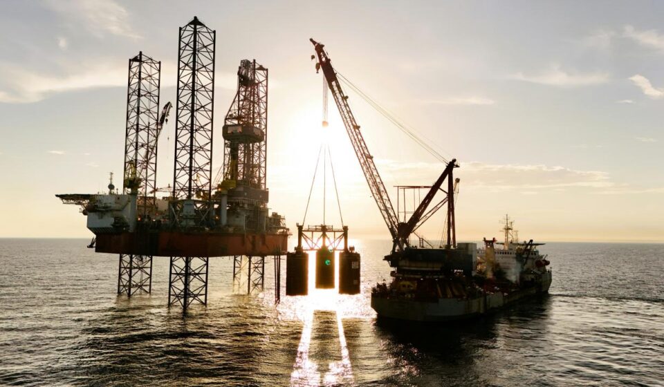 An oil rig being serviced by a supply ship