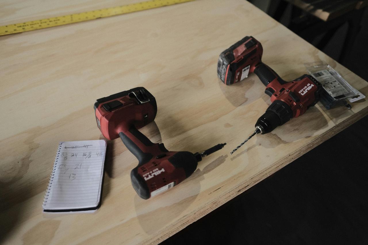 a couple of red and black toy cars on a wooden surface