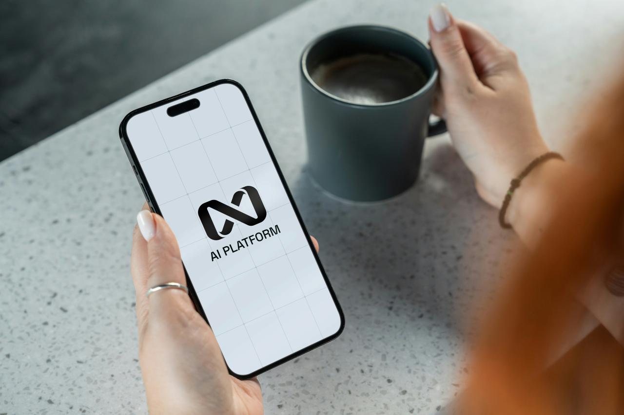 Person holding smartphone with ai platform logo