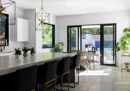 Modern kitchen with large island, bar stools, and outdoor patio