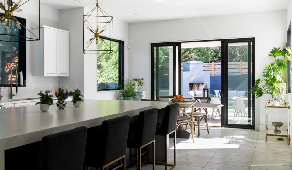 Modern kitchen with large island, bar stools, and outdoor patio