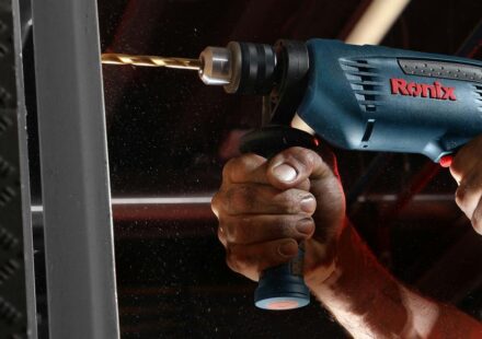 person holding blue and black cordless power drill
