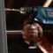 person holding blue and black cordless power drill