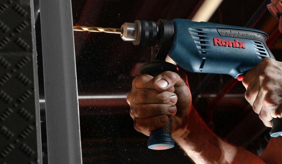person holding blue and black cordless power drill